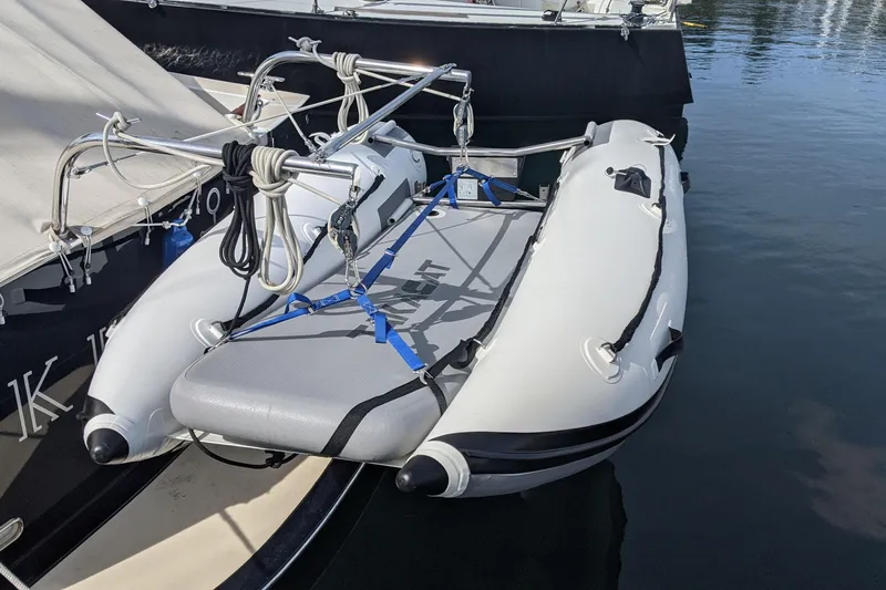 Kikiriki Yacht Photos Pics Inflatable dinghy secured on 2007 MJM 34z Downeast boat, docked in calm waters.