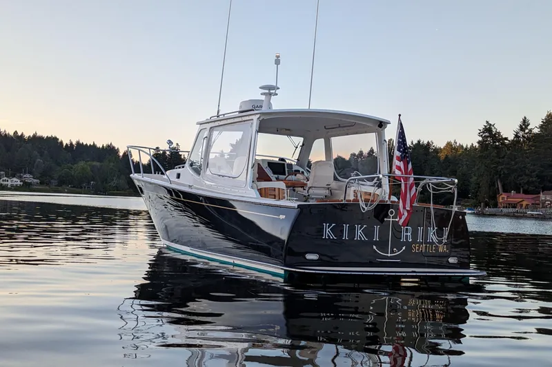 Kikiriki Yacht Photos Pics 2007 MJM 34z Downeast boat on calm water at sunset, Seattle.