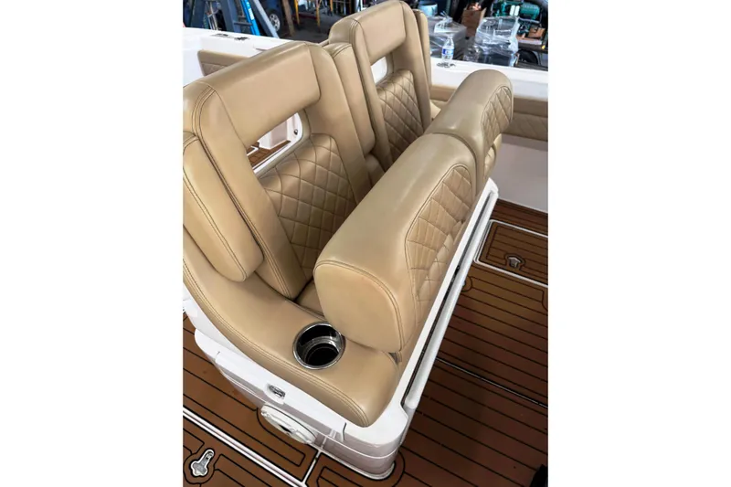 T/t Jodi Ann Yacht Photos Pics Luxurious tan seating on 2019 Intrepid 345 Nomad FE boat with diamond stitching and cup holder.