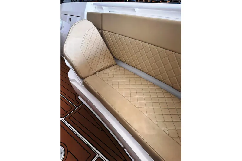 T/t Jodi Ann Yacht Photos Pics Luxurious tan seating on 2019 Intrepid 345 Nomad FE boat, featuring diamond-pattern upholstery.