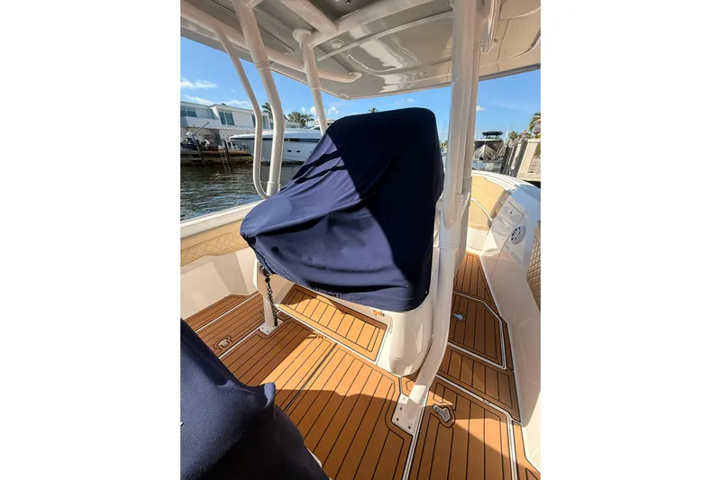T/t Jodi Ann Yacht Photos Pics 2019 Intrepid 345 Nomad FE boat interior with covered seating and teak flooring.
