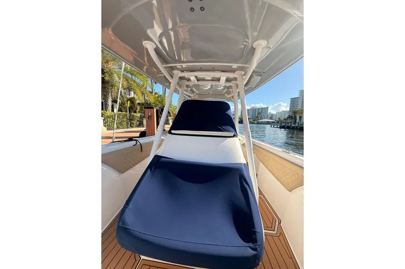 T/t Jodi Ann Yacht Photos Pics 2019 Intrepid 345 Nomad FE boat with blue seating, docked by waterfront.