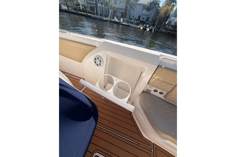 T/t Jodi Ann Yacht Photos Pics 2019 Intrepid 345 Nomad FE boat interior with cup holders and teak flooring.