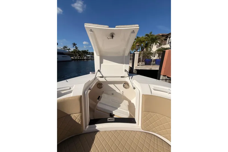 T/t Jodi Ann Yacht Photos Pics 2019 Intrepid 345 Nomad FE boat with open storage compartment, dockside view.