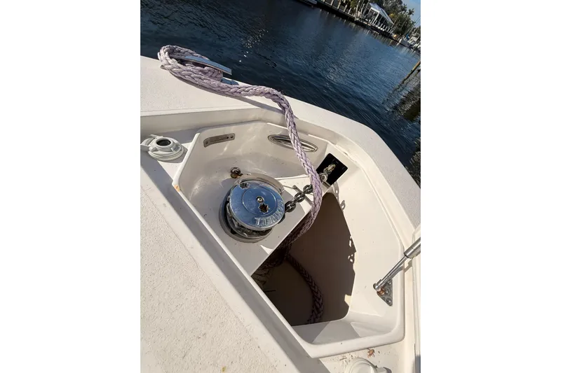 T/t Jodi Ann Yacht Photos Pics 2019 Intrepid 345 Nomad FE boat anchor compartment with rope and winch by the water.