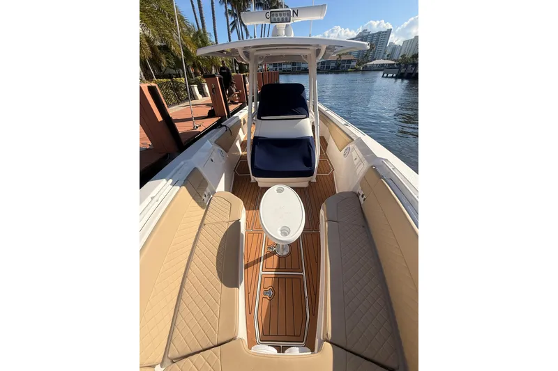 T/t Jodi Ann Yacht Photos Pics 2019 Intrepid 345 Nomad FE boat interior with tan seating and wooden deck.