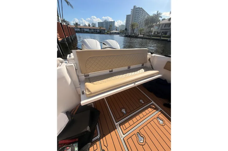 T/t Jodi Ann Yacht Photos Pics 2019 Intrepid 345 Nomad FE boat interior with tan seating and wooden deck.