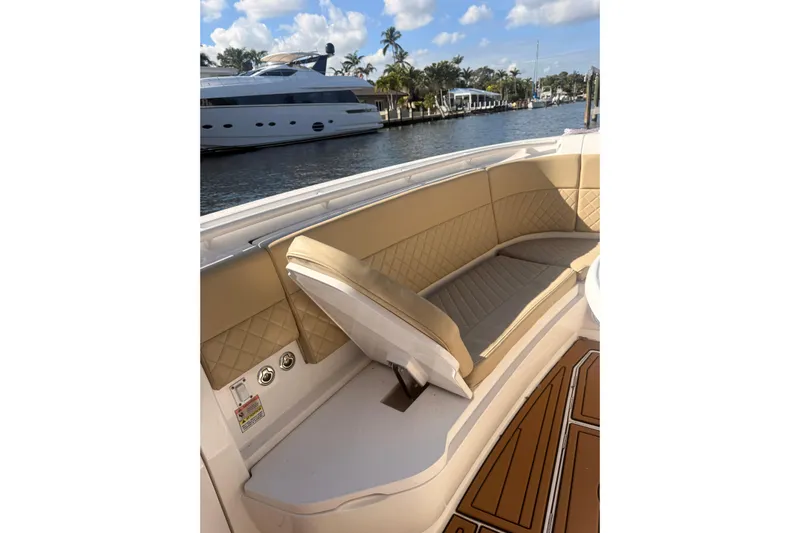 T/t Jodi Ann Yacht Photos Pics 2019 Intrepid 345 Nomad FE boat interior with tan seating and scenic waterfront view.