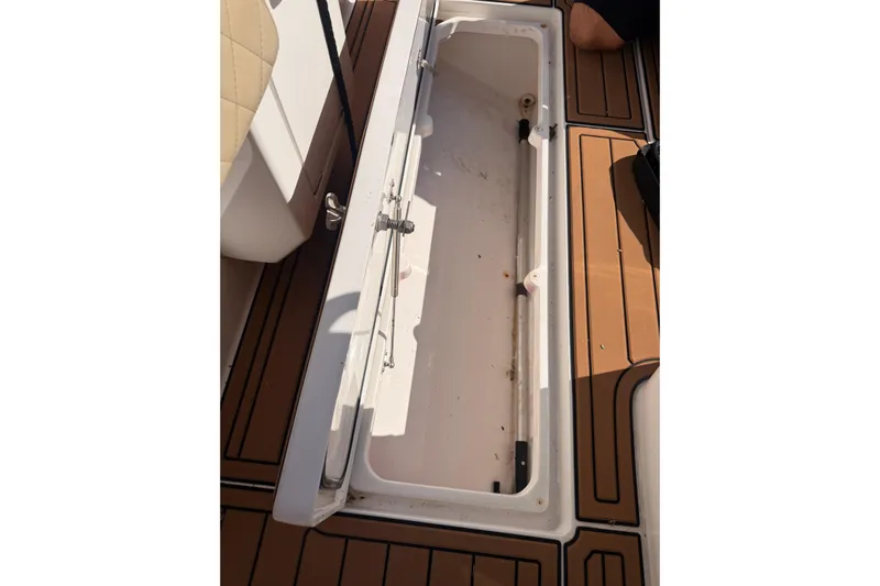 T/t Jodi Ann Yacht Photos Pics Open storage compartment on 2019 Intrepid 345 Nomad FE boat, featuring teak-style flooring.