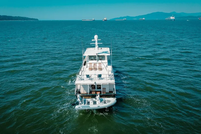 North Yacht Photos Pics Aerial view of 2002 Darling Yachts Custom Aluminum yacht cruising on open sea.