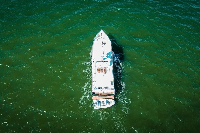 North Yacht Photos Pics Aerial view of 2002 Darling Yachts Custom Aluminum boat on green water.