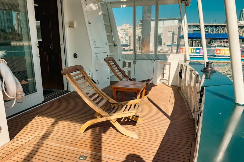North Yacht Photos Pics Deck of 2002 Darling Yachts Custom Aluminum with wooden chairs and table.