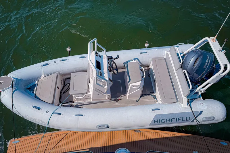 North Yacht Photos Pics Inflatable boat with Yamaha motor, viewed from above, docked on water.
