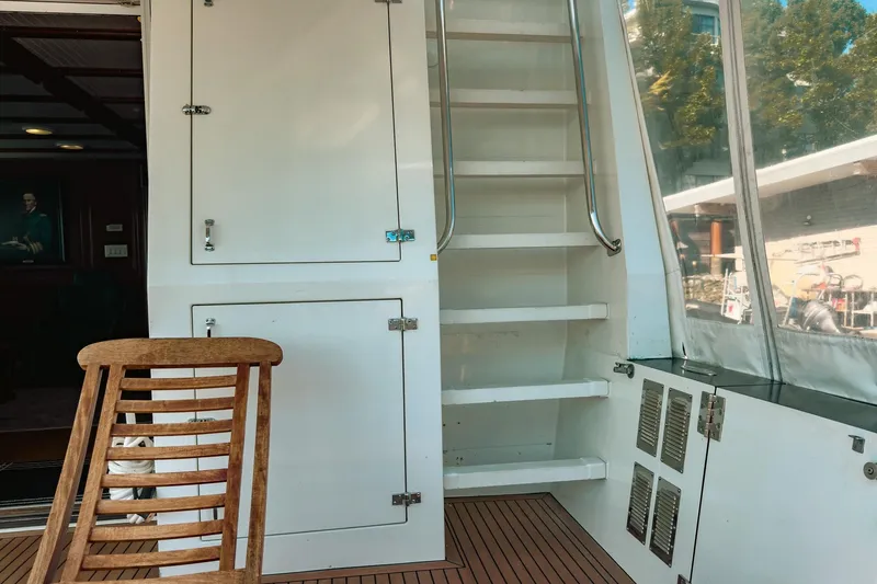North Yacht Photos Pics Interior of 2002 Darling Yachts Custom Aluminum with wooden chair and staircase.
