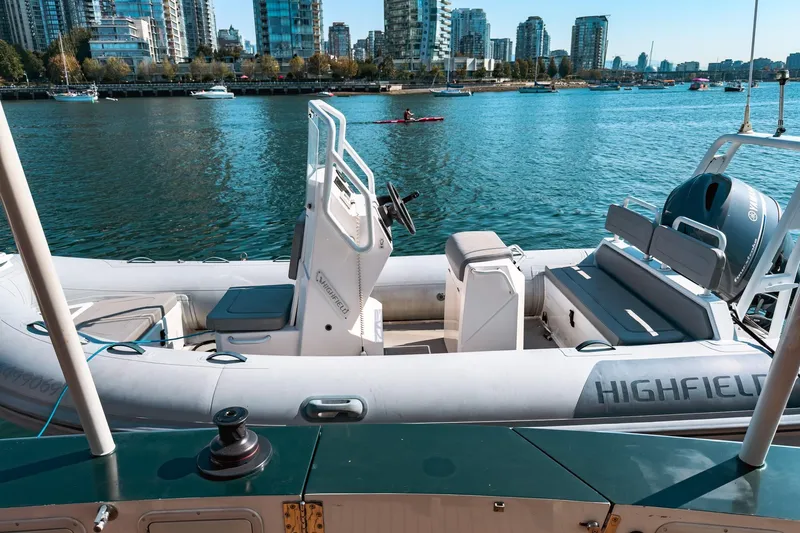 North Yacht Photos Pics Custom Aluminum yacht by Darling Yachts, 2002, docked with city skyline in background.