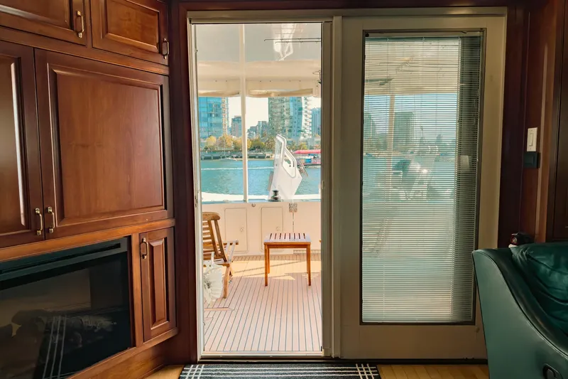 North Yacht Photos Pics Interior view of 2002 Darling Yachts Custom Aluminum, featuring wooden cabinetry and outdoor deck.