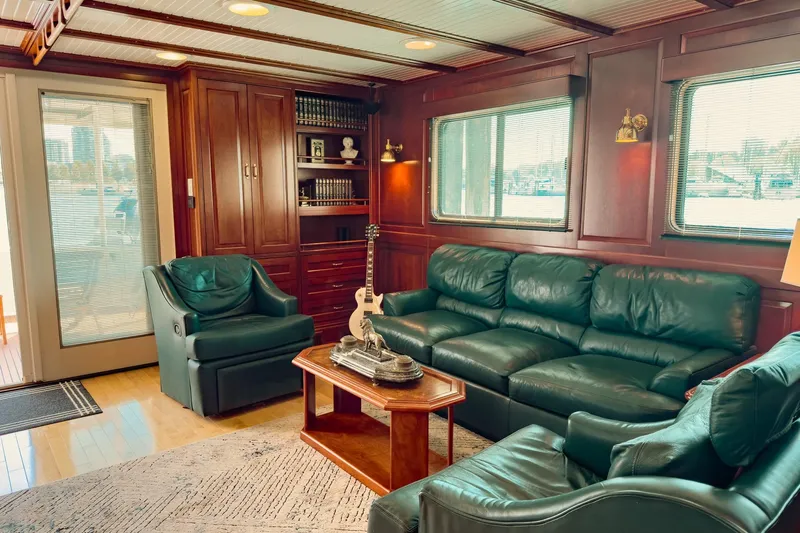 North Yacht Photos Pics Luxurious yacht interior with green leather seating, wood paneling, and a guitar, Darling Yachts 2002.