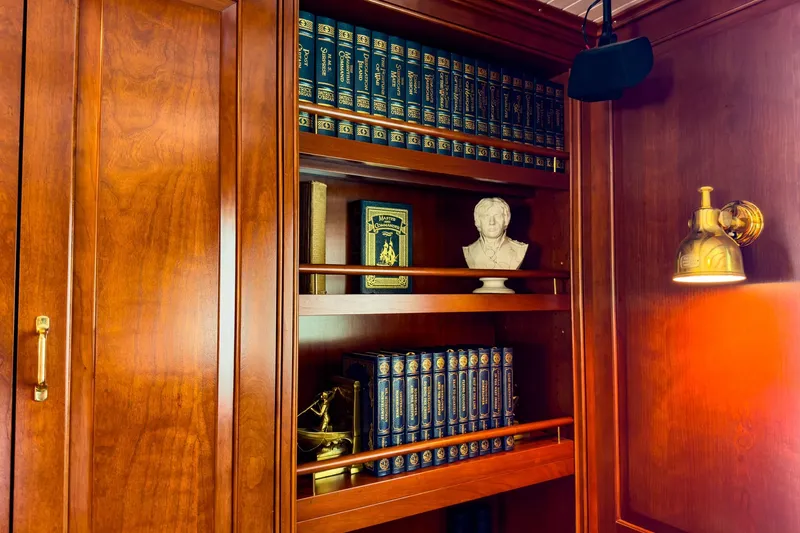 North Yacht Photos Pics Luxurious wooden yacht interior with books, bust, and brass lamp, Darling Yachts Custom Aluminum 2002.