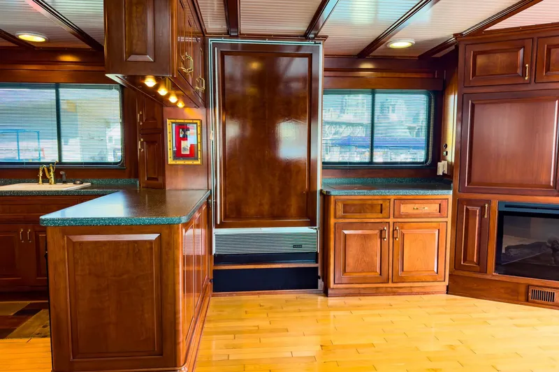 North Yacht Photos Pics Luxurious yacht interior with wooden cabinetry, modern kitchen, and elegant design, Darling Yachts 2002 model.