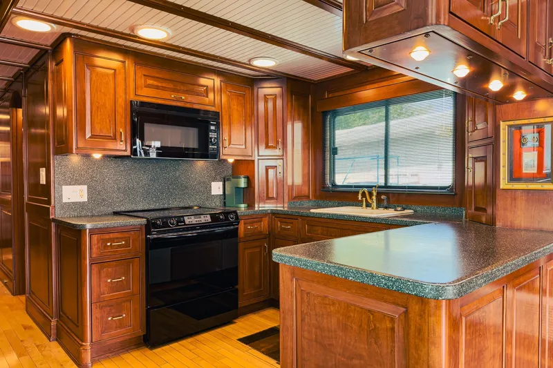 North Yacht Photos Pics Luxurious yacht kitchen with wooden cabinetry, modern appliances, and ample counter space, Darling Yachts 2002.