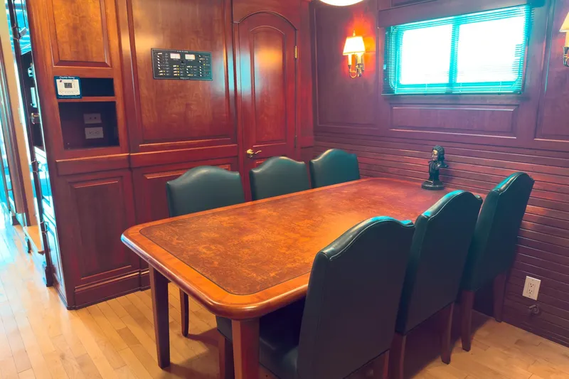 North Yacht Photos Pics Luxurious dining area on 2002 Darling Yachts Custom Aluminum, featuring elegant wood paneling.