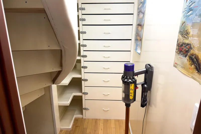 North Yacht Photos Pics Interior of 2002 Darling Yachts Custom Aluminum with staircase, storage drawers, and vacuum cleaner.