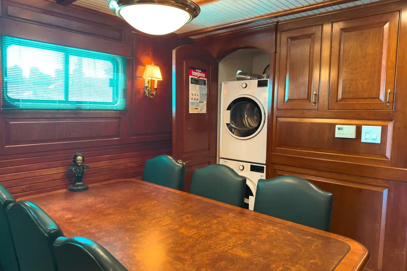 North Yacht Photos Pics Luxurious yacht interior with wood paneling, dining area, and washer-dryer unit, Darling Yachts 2002.