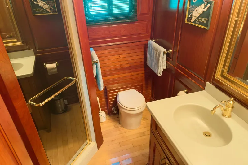 North Yacht Photos Pics Luxurious yacht bathroom with wood paneling, gold fixtures, and elegant decor, Darling Yachts 2002 model.