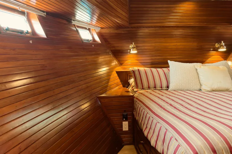 North Yacht Photos Pics Luxurious wooden cabin interior of 2002 Darling Yachts Custom Aluminum, featuring cozy bed and lighting.