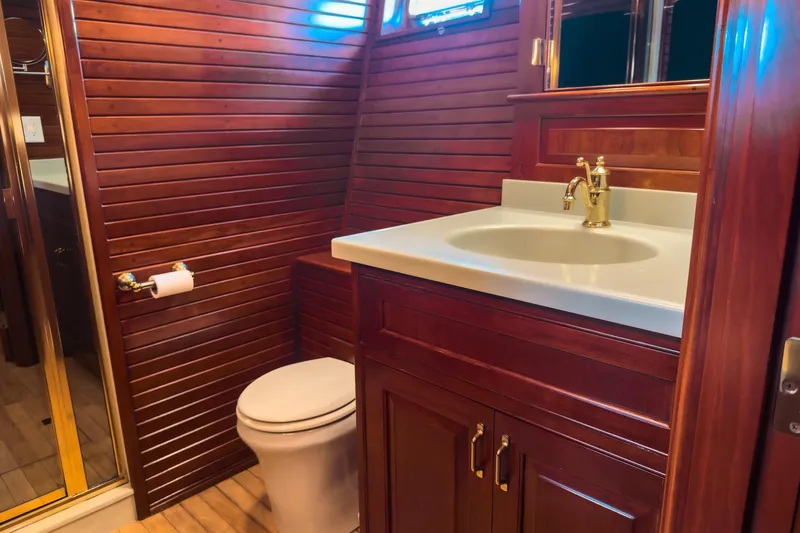 North Yacht Photos Pics Luxurious yacht bathroom with wooden paneling, elegant sink, and toilet. Darling Yachts Custom Aluminum 2002.
