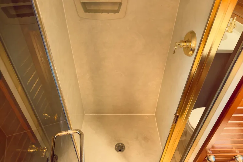 North Yacht Photos Pics Shower area in 2002 Darling Yachts Custom Aluminum, featuring gold fixtures and glass door.