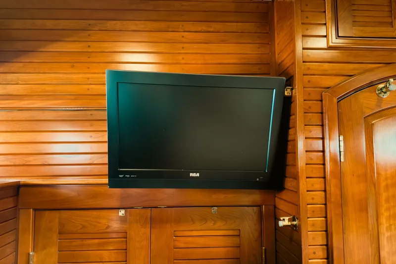 North Yacht Photos Pics Wall-mounted TV on wooden paneling inside 2002 Darling Yachts Custom Aluminum.