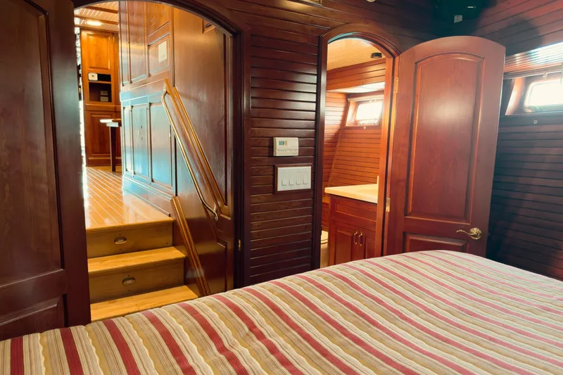 North Yacht Photos Pics Luxurious wooden interior of 2002 Darling Yachts Custom Aluminum, featuring bedroom and bathroom.