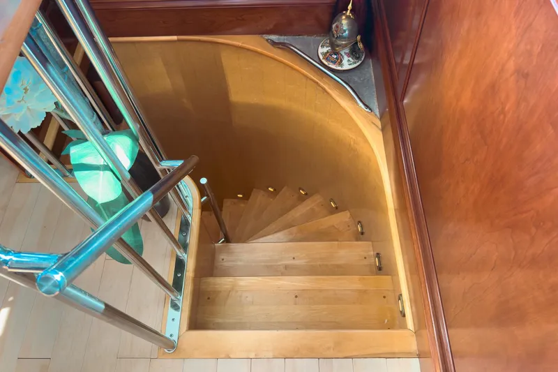 North Yacht Photos Pics Wooden spiral staircase on a 2002 Darling Yachts Custom Aluminum boat interior.