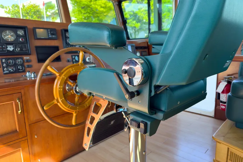 North Yacht Photos Pics Captain's chair and helm of 2002 Darling Yachts Custom Aluminum boat, featuring wooden steering wheel.