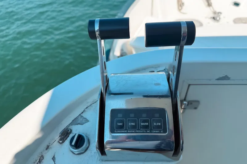 North Yacht Photos Pics Throttle controls on a 2002 Darling Yachts Custom Aluminum boat, overlooking water.