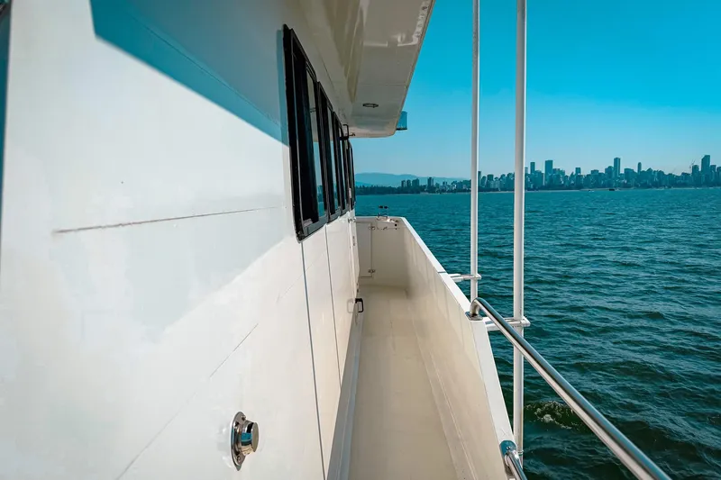 North Yacht Photos Pics Side view of 2002 Darling Yachts Custom Aluminum, overlooking city skyline and ocean.