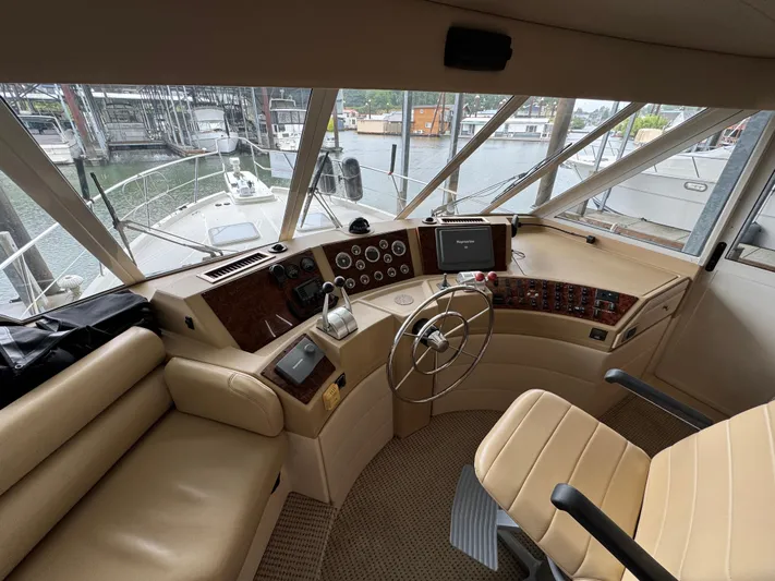  Yacht Photos Pics 2005 Meridian 490 Pilothouse interior with steering wheel and control panel.