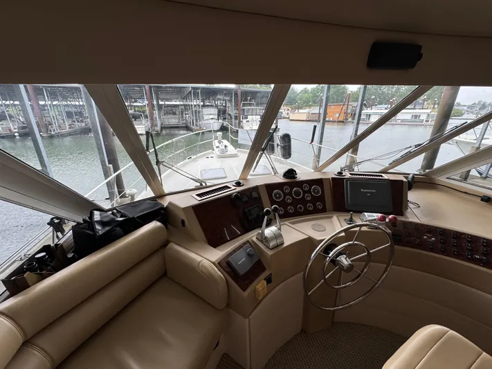  Yacht Photos Pics Interior view of 2005 Meridian 490 Pilothouse yacht helm with steering wheel and controls.