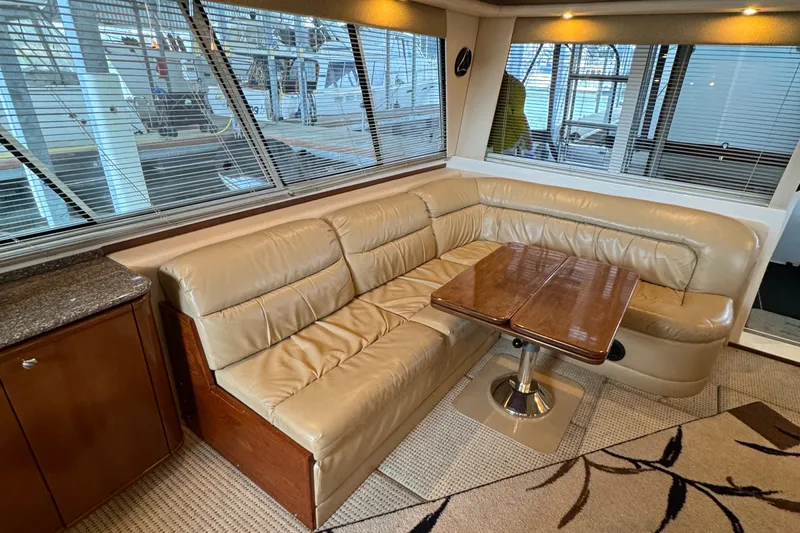  Yacht Photos Pics Luxurious interior of 2005 Meridian 490 Pilothouse with leather seating and wooden table.