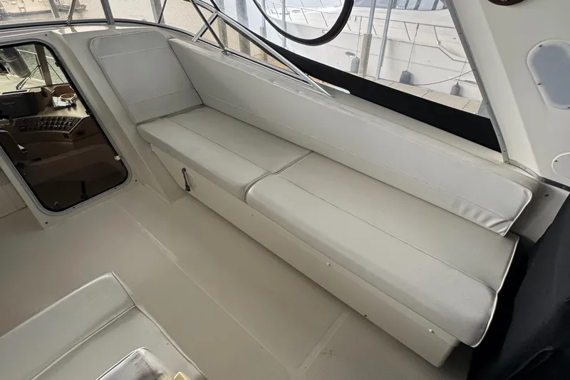  Yacht Photos Pics 2005 Meridian 490 Pilothouse interior with white seating and helm view.