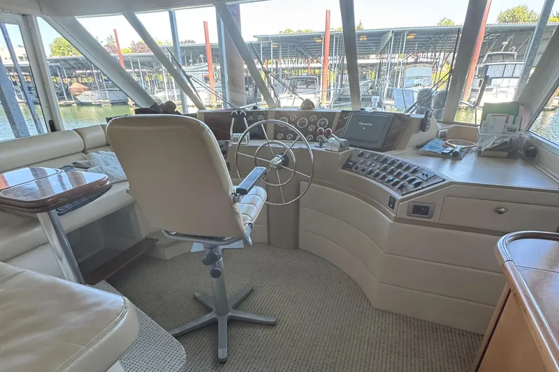  Yacht Photos Pics 2005 Meridian 490 Pilothouse interior with steering wheel and control panel.