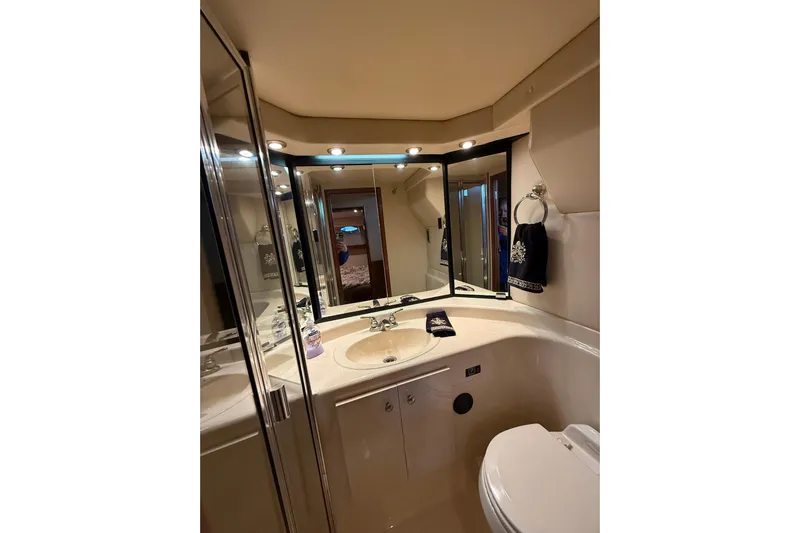  Yacht Photos Pics Luxurious bathroom in 2005 Meridian 490 Pilothouse yacht with elegant fixtures and lighting.