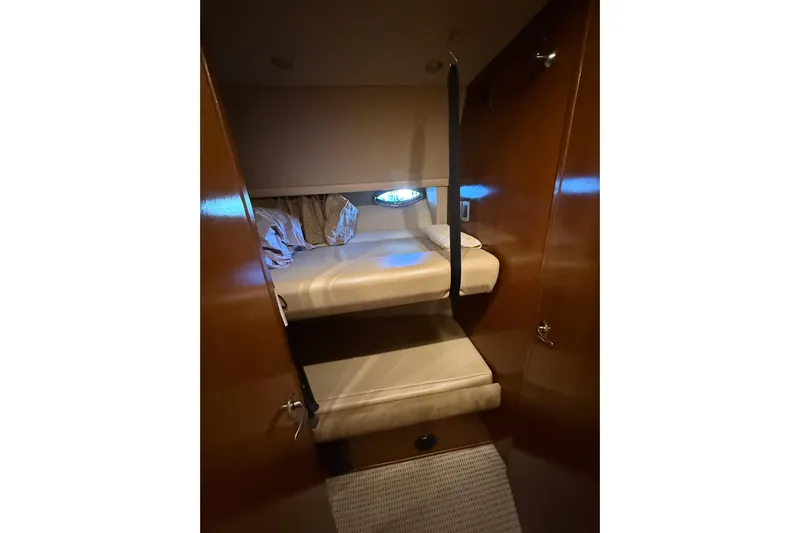  Yacht Photos Pics 2005 Meridian 490 Pilothouse cabin with cozy bunk beds and wooden interior.