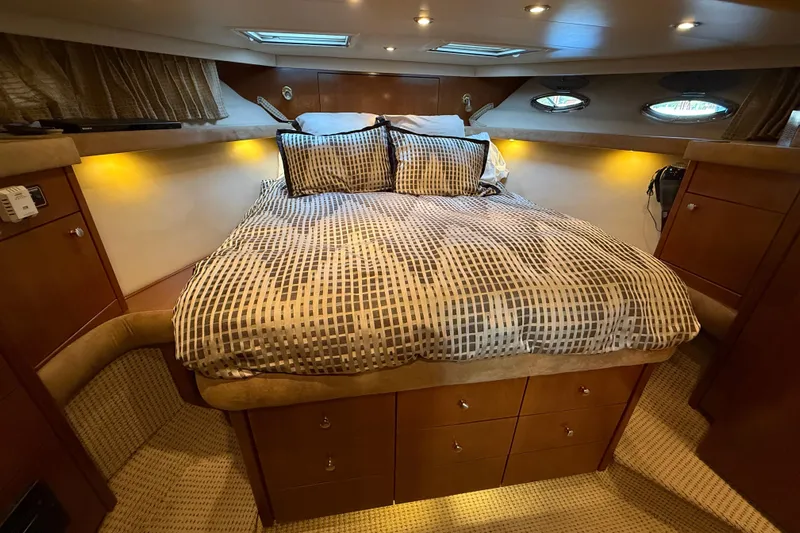  Yacht Photos Pics Luxurious cabin interior of 2005 Meridian 490 Pilothouse yacht with cozy bed and ambient lighting.