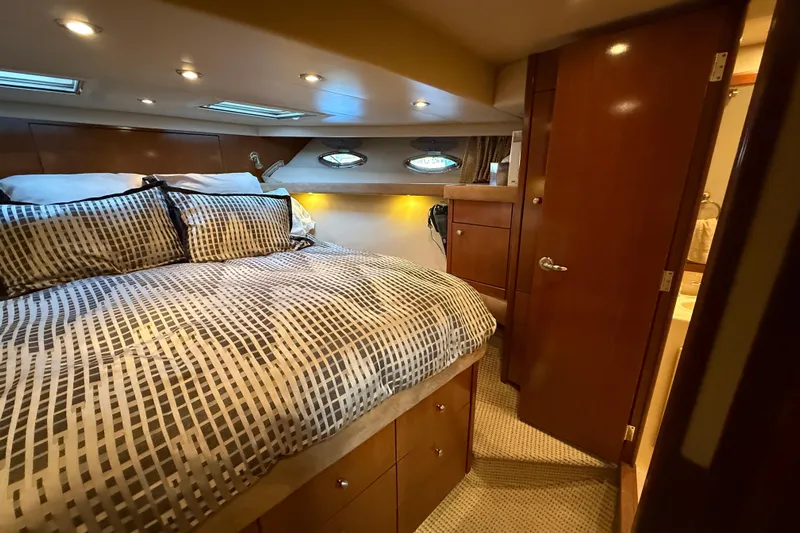  Yacht Photos Pics Luxurious bedroom interior of 2005 Meridian 490 Pilothouse yacht with elegant bedding.