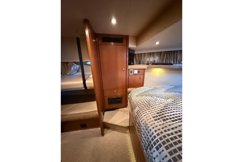  Yacht Photos Pics 2005 Meridian 490 Pilothouse interior cabin with wood paneling and cozy bedding.