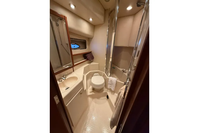  Yacht Photos Pics Luxurious bathroom in 2005 Meridian 490 Pilothouse yacht with modern fixtures and lighting.