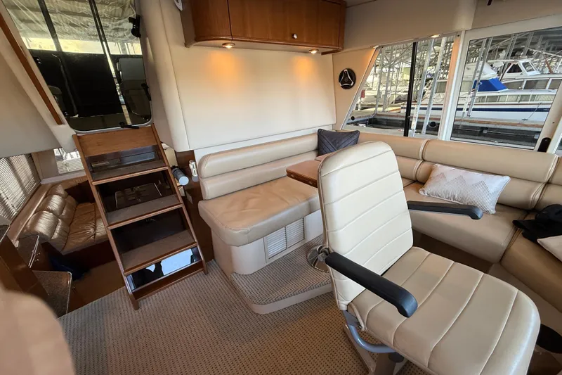  Yacht Photos Pics Interior of 2005 Meridian 490 Pilothouse yacht with beige seating and wooden accents.