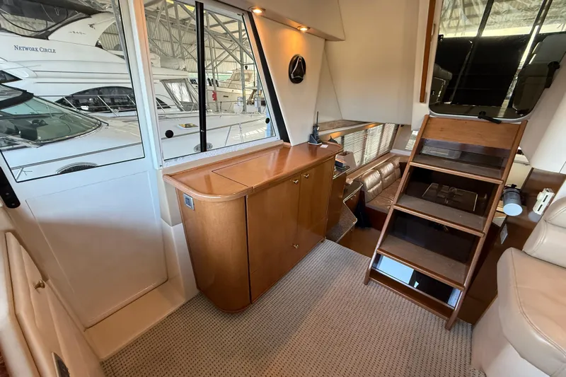  Yacht Photos Pics Interior of 2005 Meridian 490 Pilothouse yacht with wooden cabinetry and stairs.